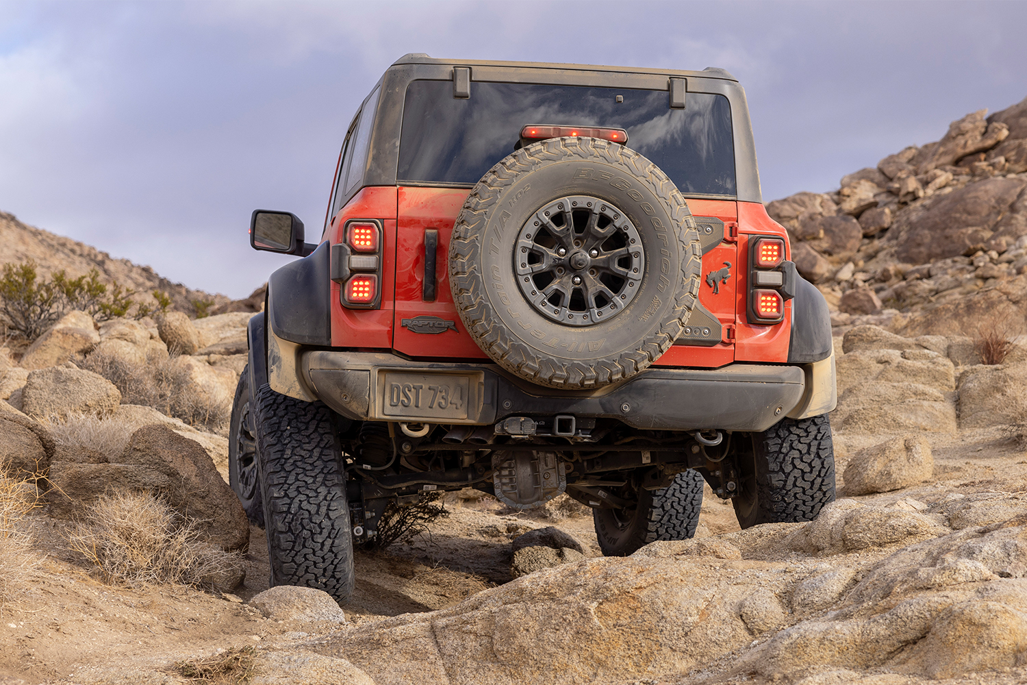 The Ford Bronco Raptor crawling over rocks in the desert