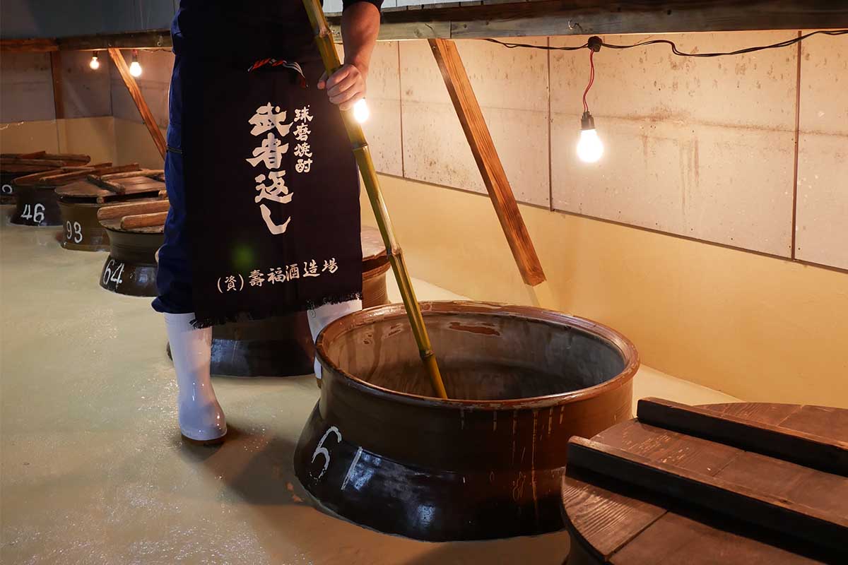A man mixing a shochu mash