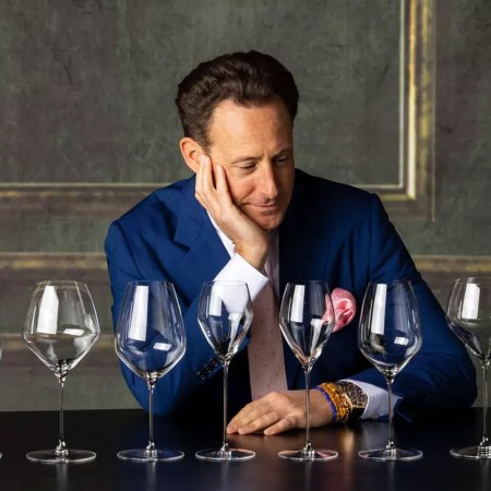 Head of Riedel Austrian glass manufacturer, Maximilian Riedel, tastes wine in his company's stand at Vinexpo wine fair in Bordeaux, southwestern France on May 13, 2019