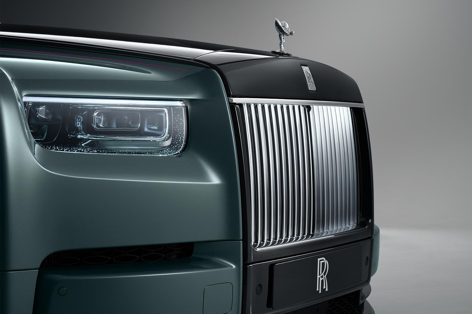A close-up of the Rolls-Royce Phantom Series II grille and headlights with laser-cut starlight