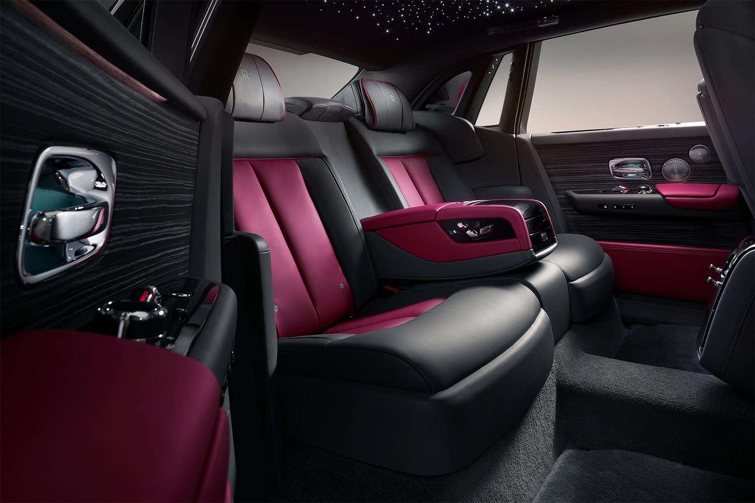 The interior of a Rolls-Royce Phantom Series II with black and maroon fabrics