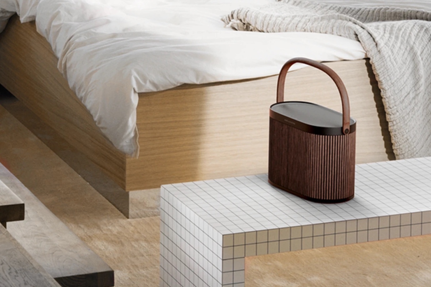 a woven Bang & Olufsen Beosound A5 on a bench