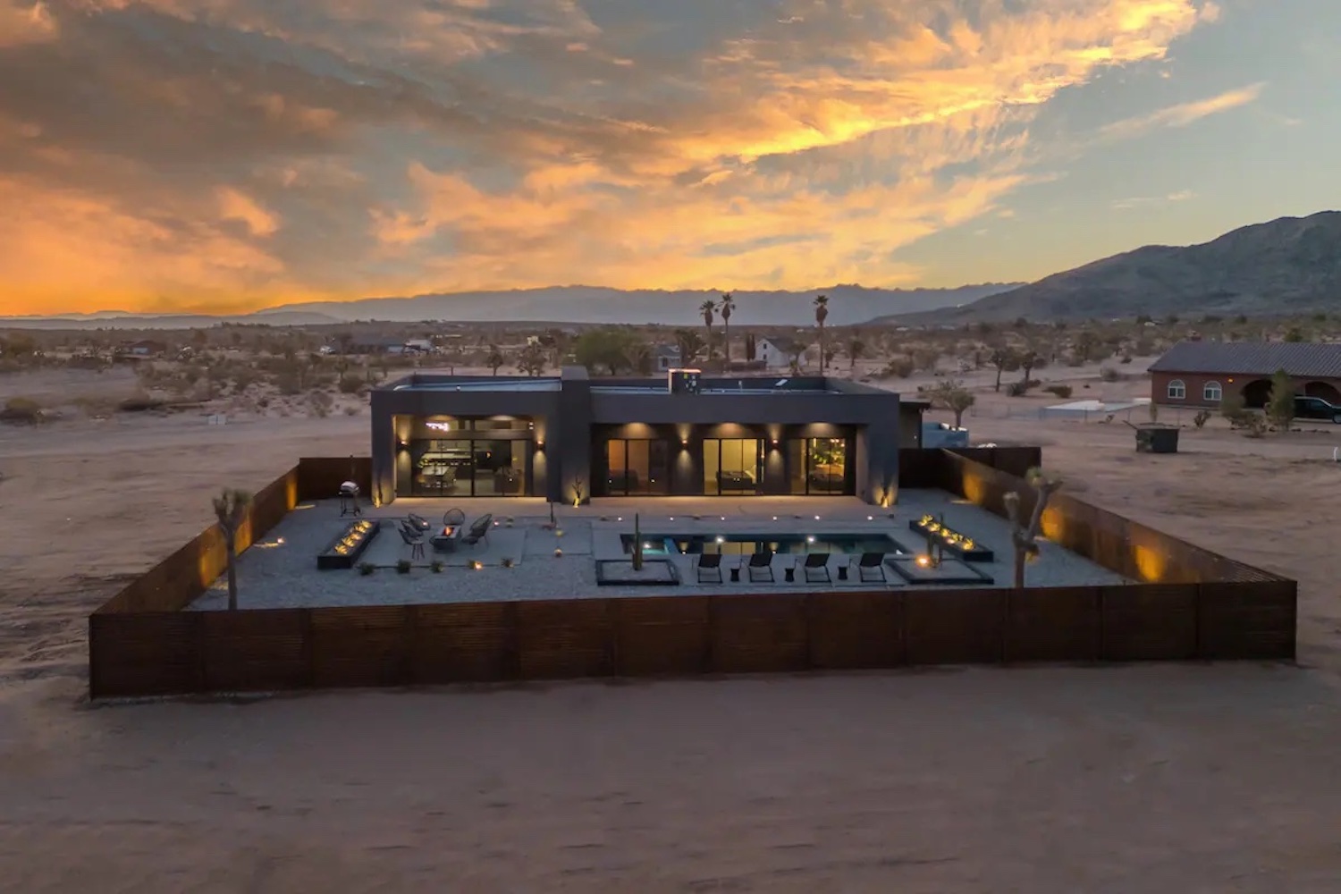A wide view of Black Sky House and private yard and fence.