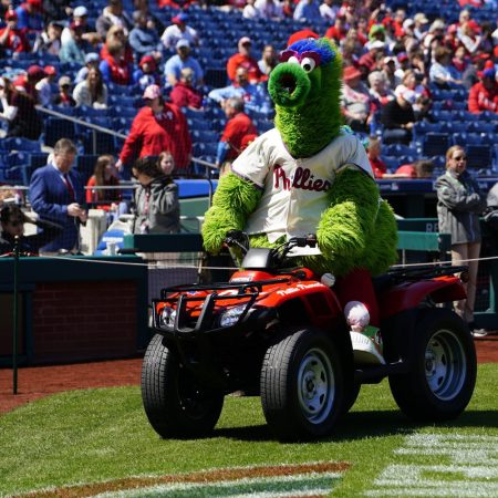 The Philly Phanatic rides around on a ride dirt bike on the baseball field