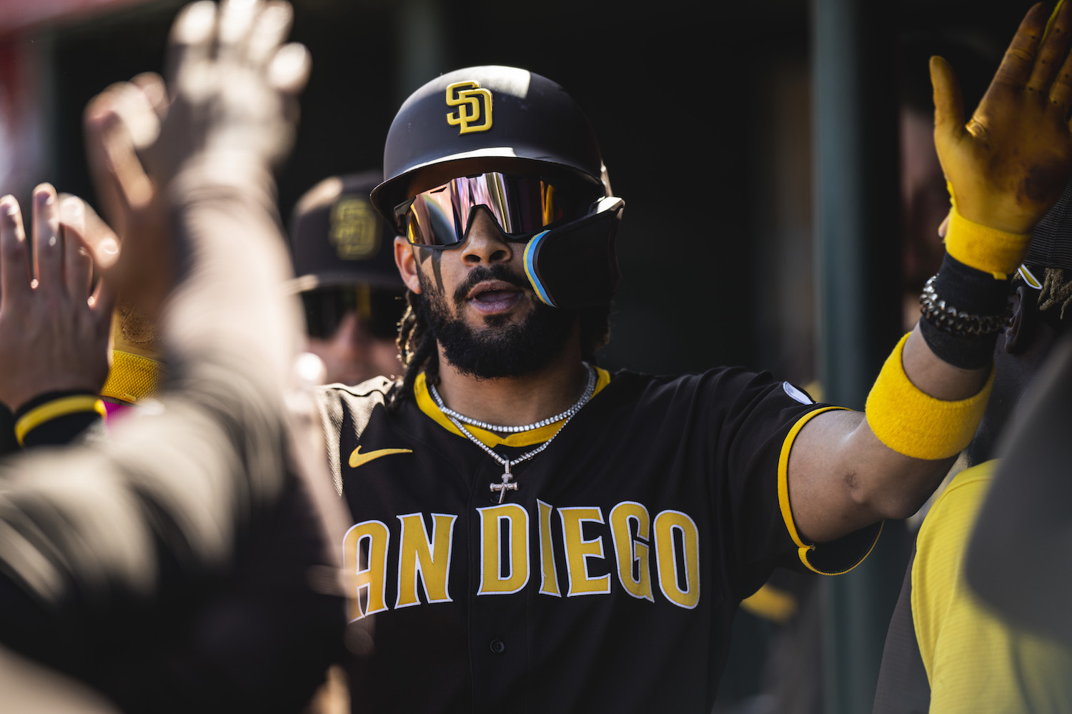 Fernando Tatis Jr. of the San Diego Padres celebrates in the dugout after hitting a home run during a spring training game against the Los Angeles Angels