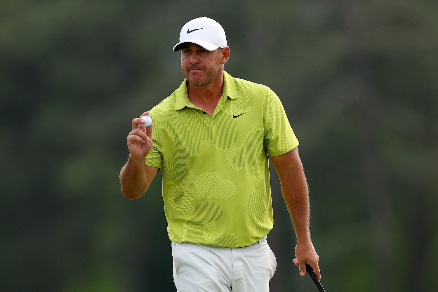 Brooks Koepka reacts to his birdie on the 18th green during the first round of the 2023 Masters Tournament
