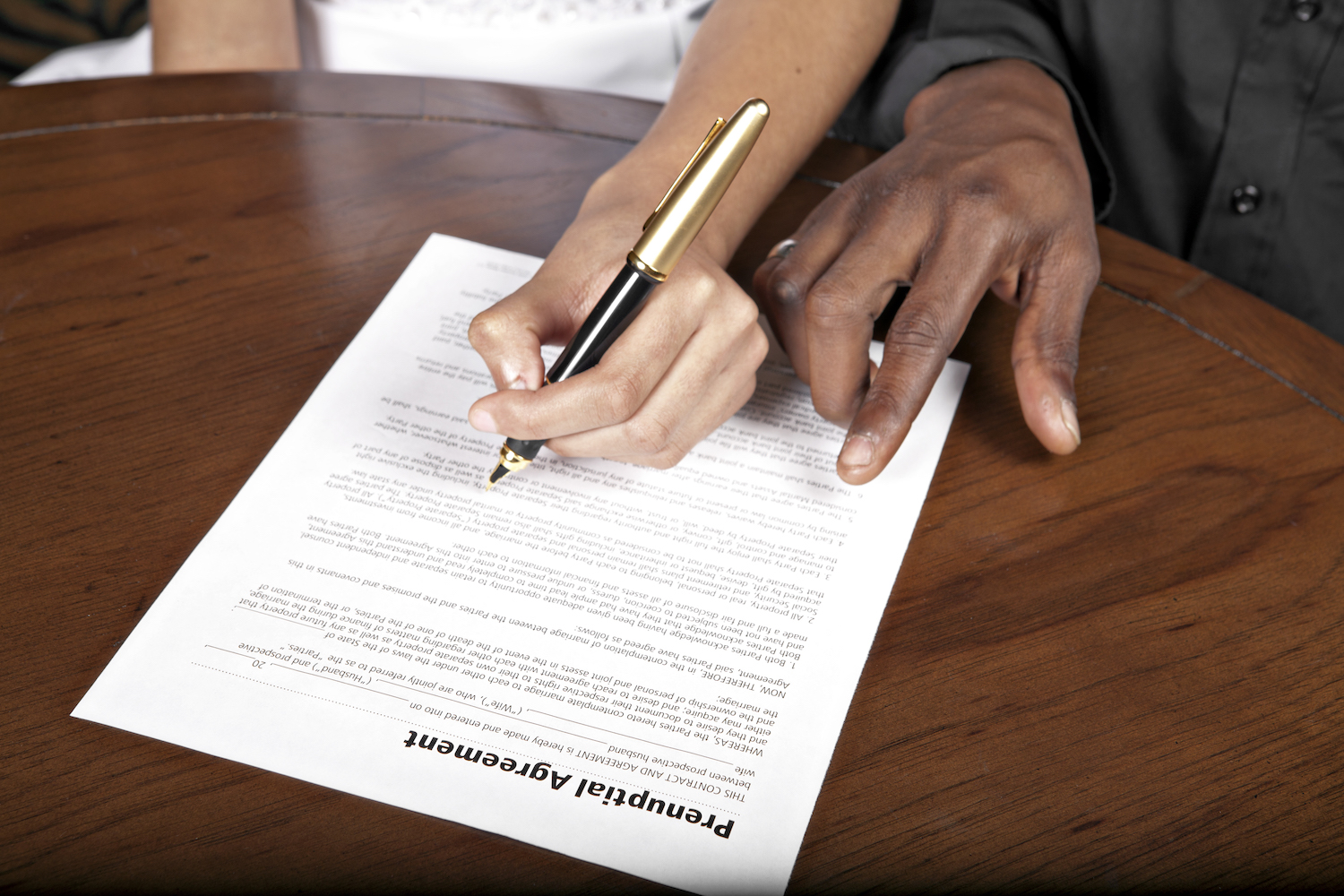 couple signing a Prenuptial agreement