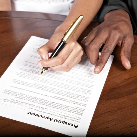 couple signing a Prenuptial agreement