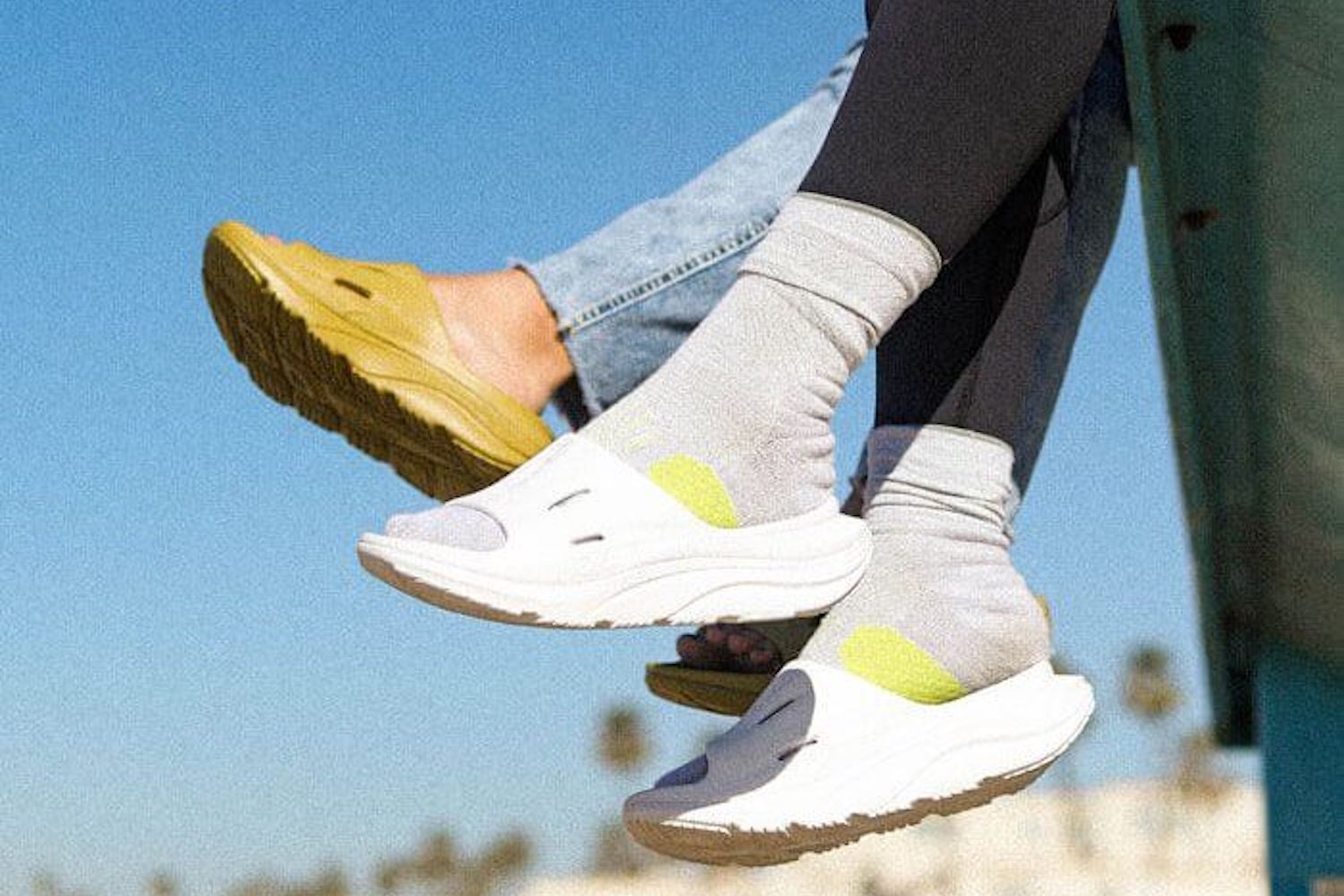 two models wearing the Hoka ORA Recovery Slide 3