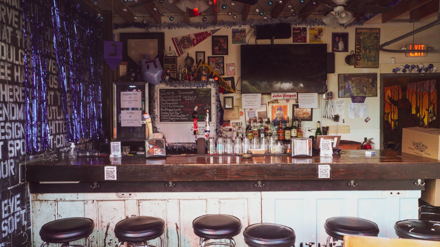 Barstools lined up at a decorative bar.