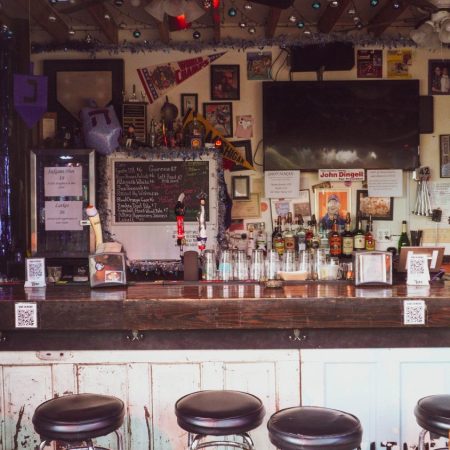 Barstools lined up at a decorative bar.