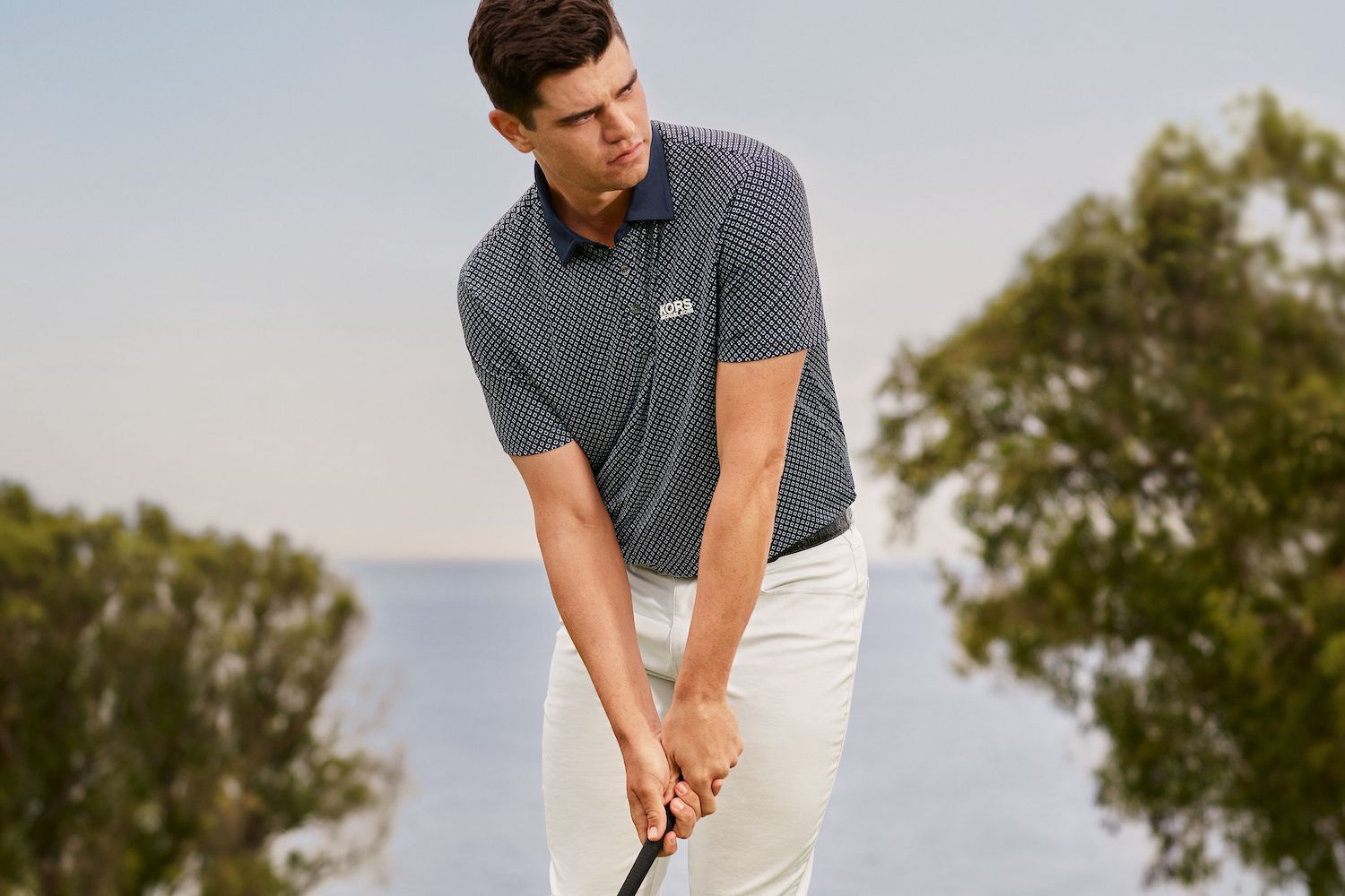 a model in Michael Kors golf collection on a golf course