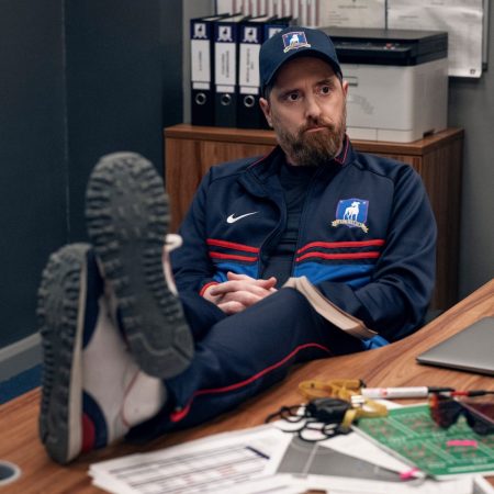 Coach Beard from Ted Lasso at his desk.