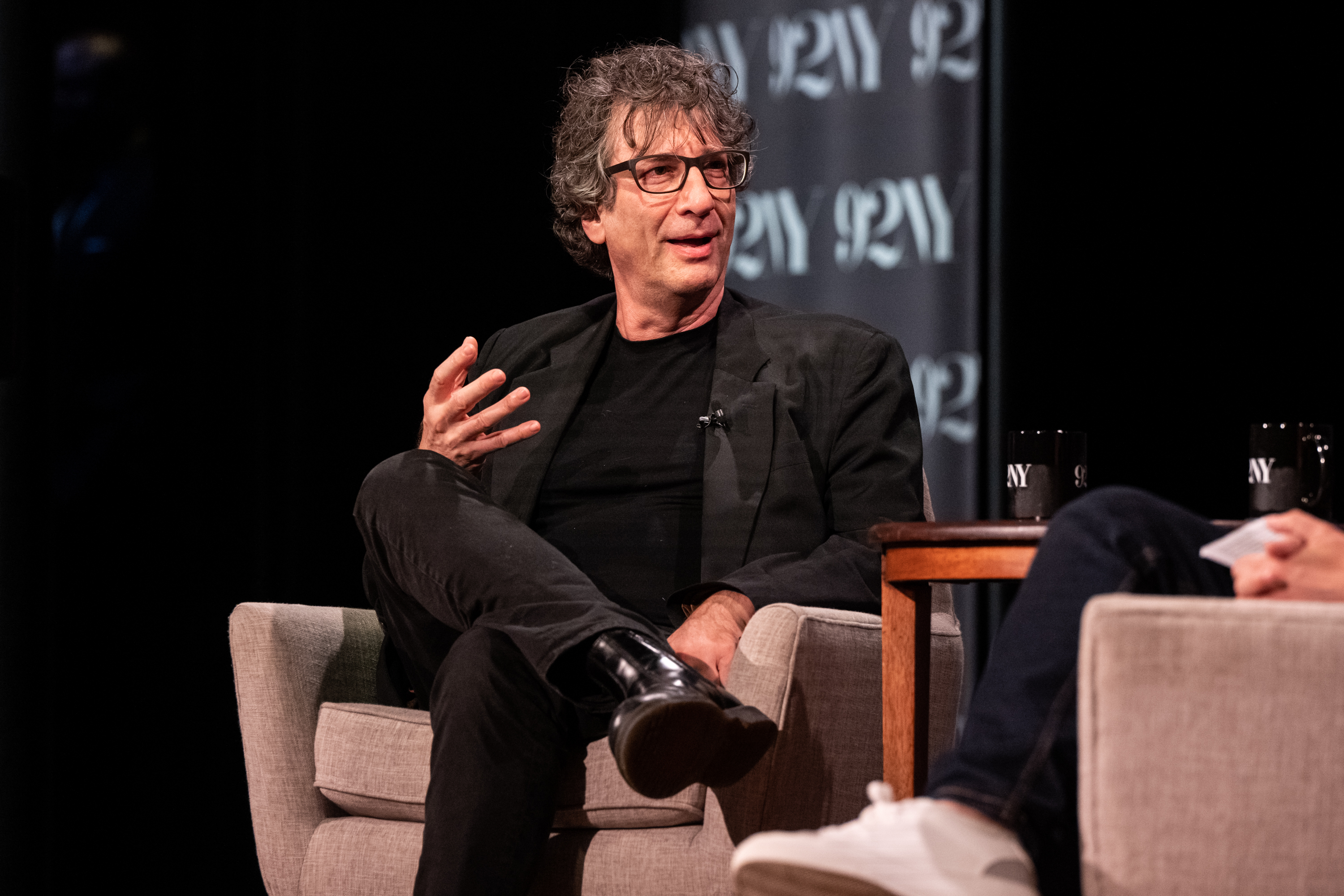 Neil Gaiman on stage at a talk in New York City.