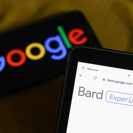 Google's new Bard AI chatbot website open on a laptop with the Google logo in the background