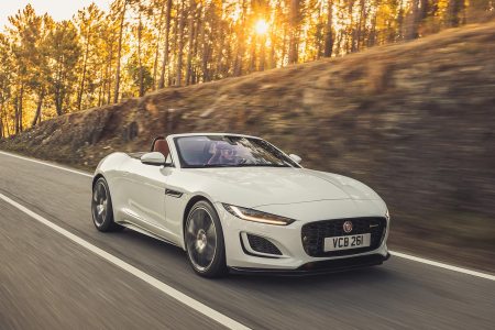 2023 Jaguar F-Type Convertible in white driving fast while the sun sets