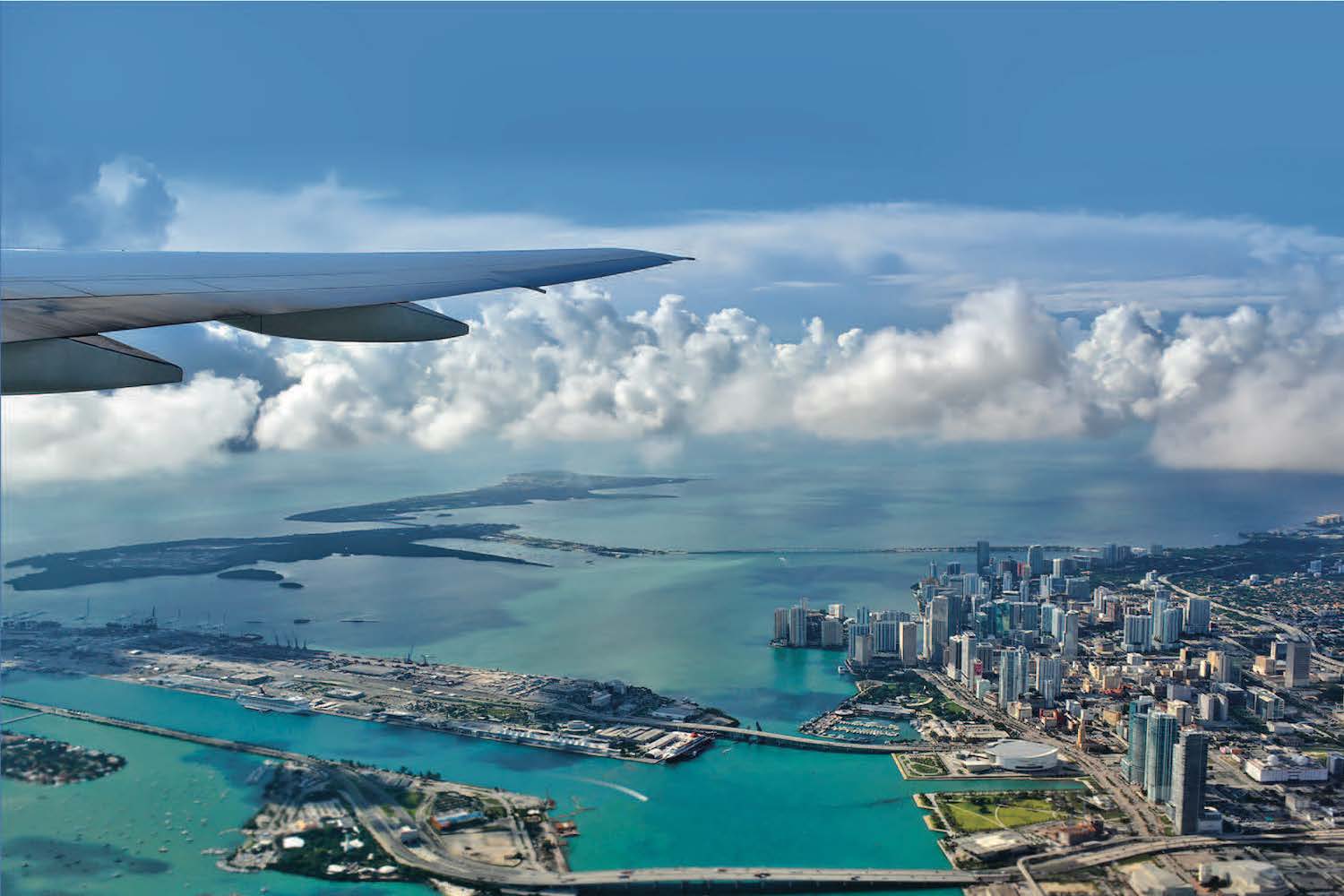 Airplane flying over an ocean and bodies of land.