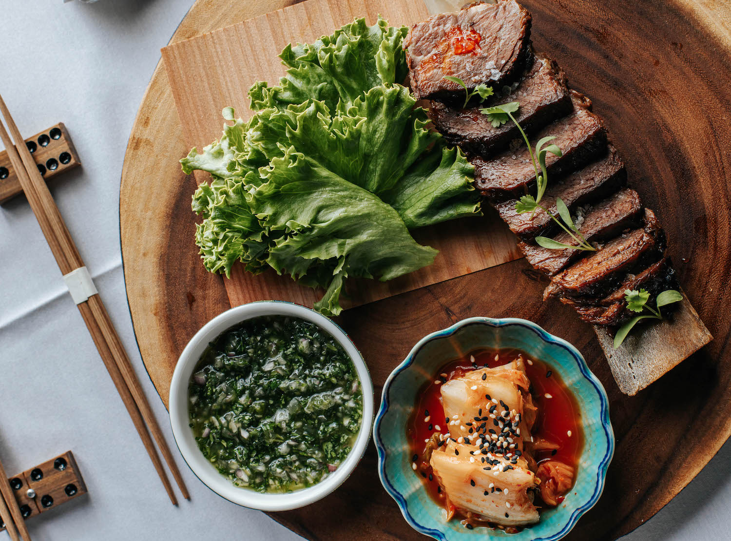 sliced meat on a tray with greens.