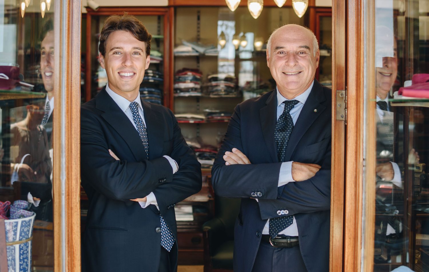 Maurizio Marinella poses in a doorway with another man.