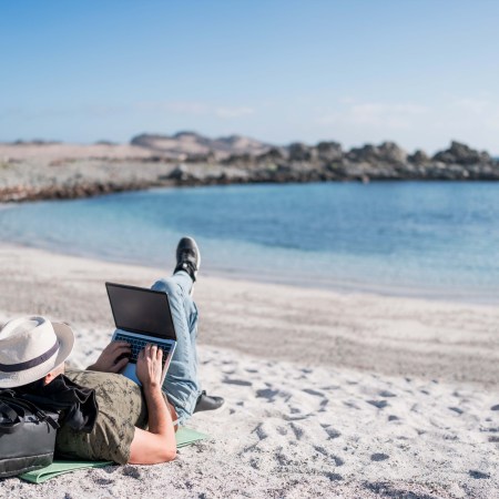 A digital nomad lounging on the beach