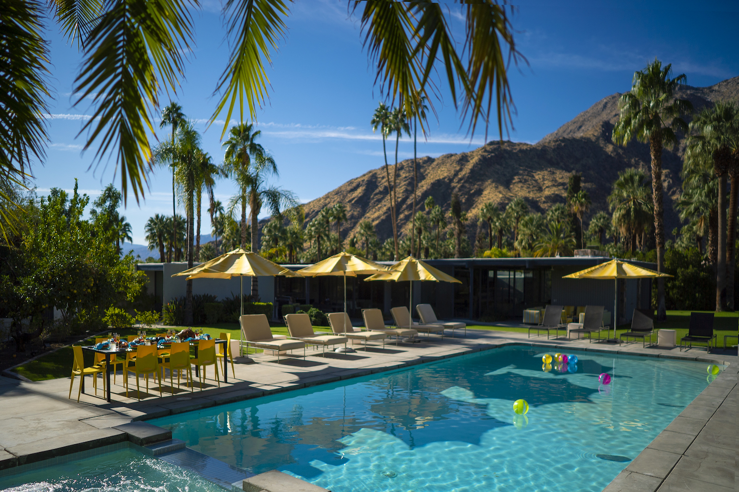 pool with umbrellas and chairs on a sunny day
