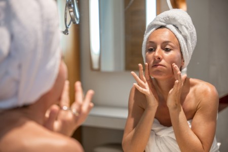 Woman in bathroom worried about her wrinkles