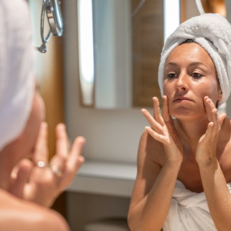Woman in bathroom worried about her wrinkles