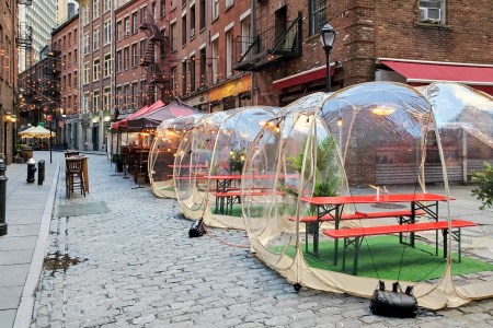 Outdoor dining tables in bubbles along Stone Street during the coronavirus pandemic in downtown Manhattan, New York City NYC