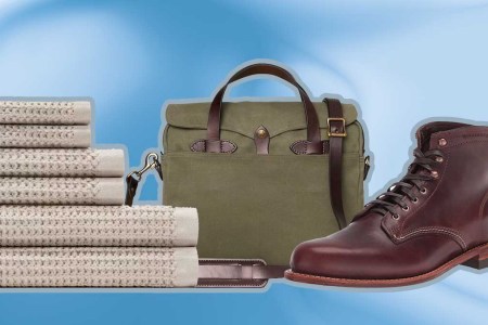 Onsen towel bundle, Filson briefcase and Wolverine 1000 mile boots, some of the best graduation gifts of 2023, on a blue background