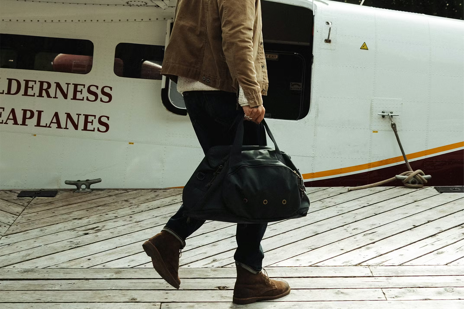lifestyle image of man holding duffle bag