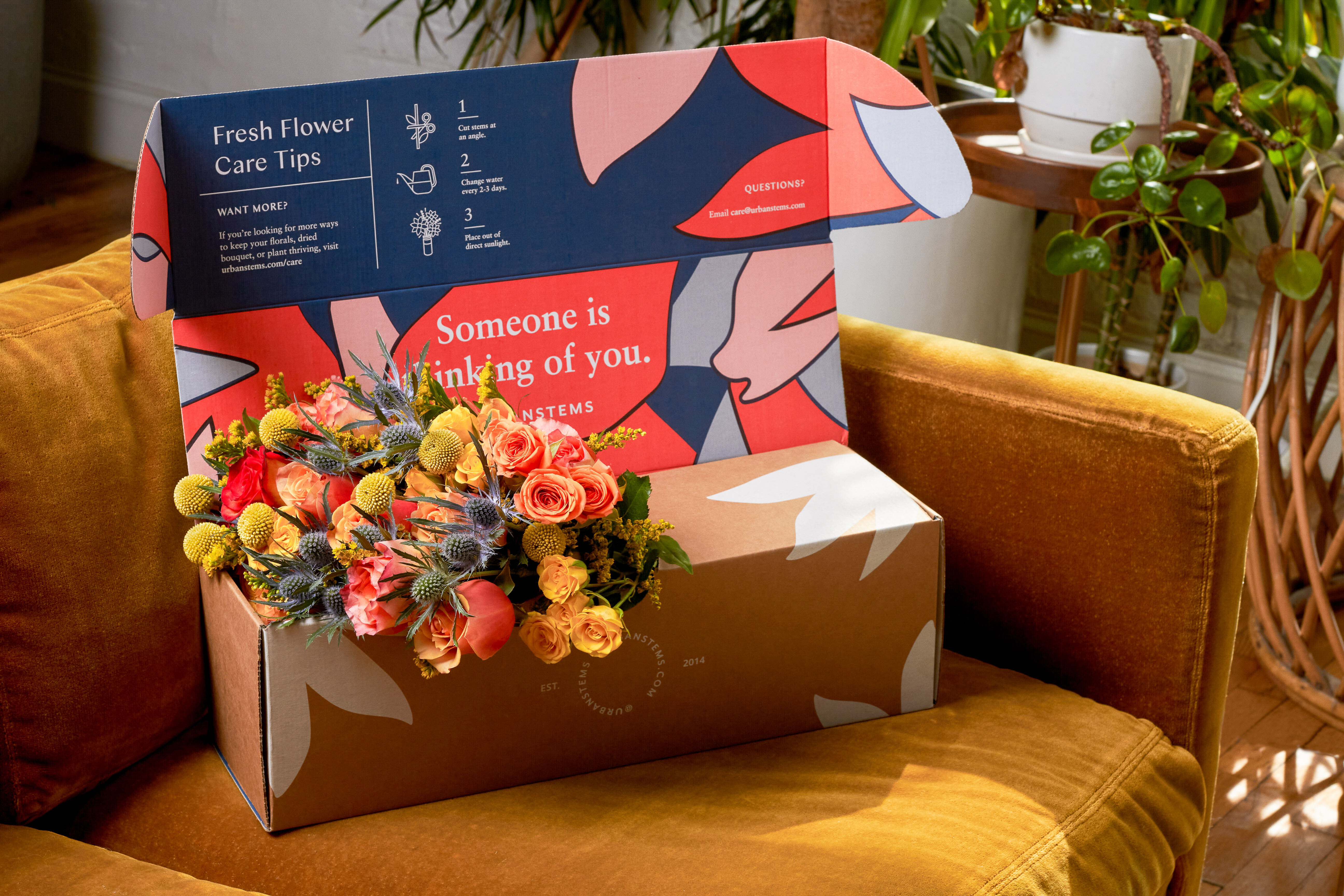 a box of flowers on a yellow chair