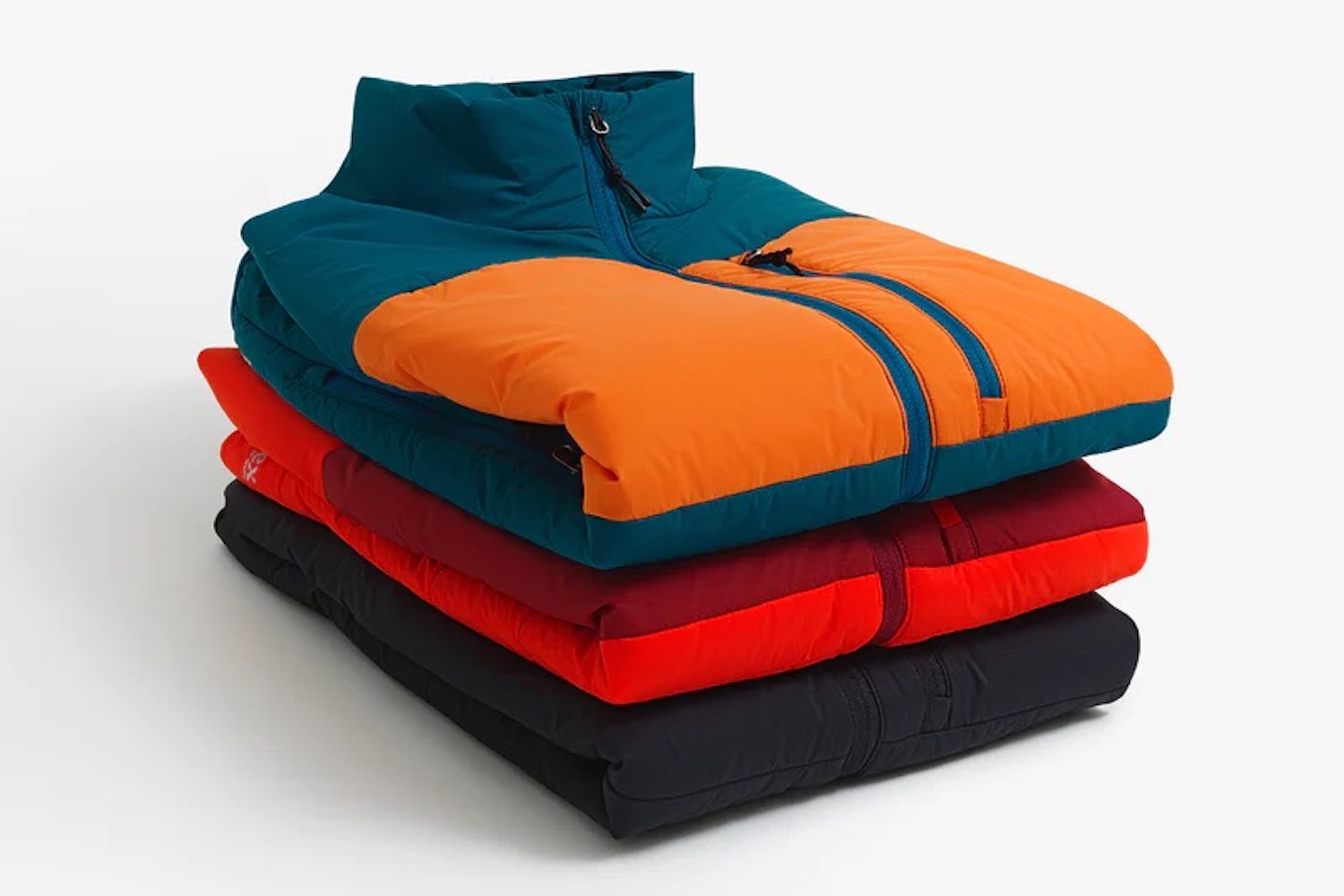 a stack of Ibex jackets on a white background