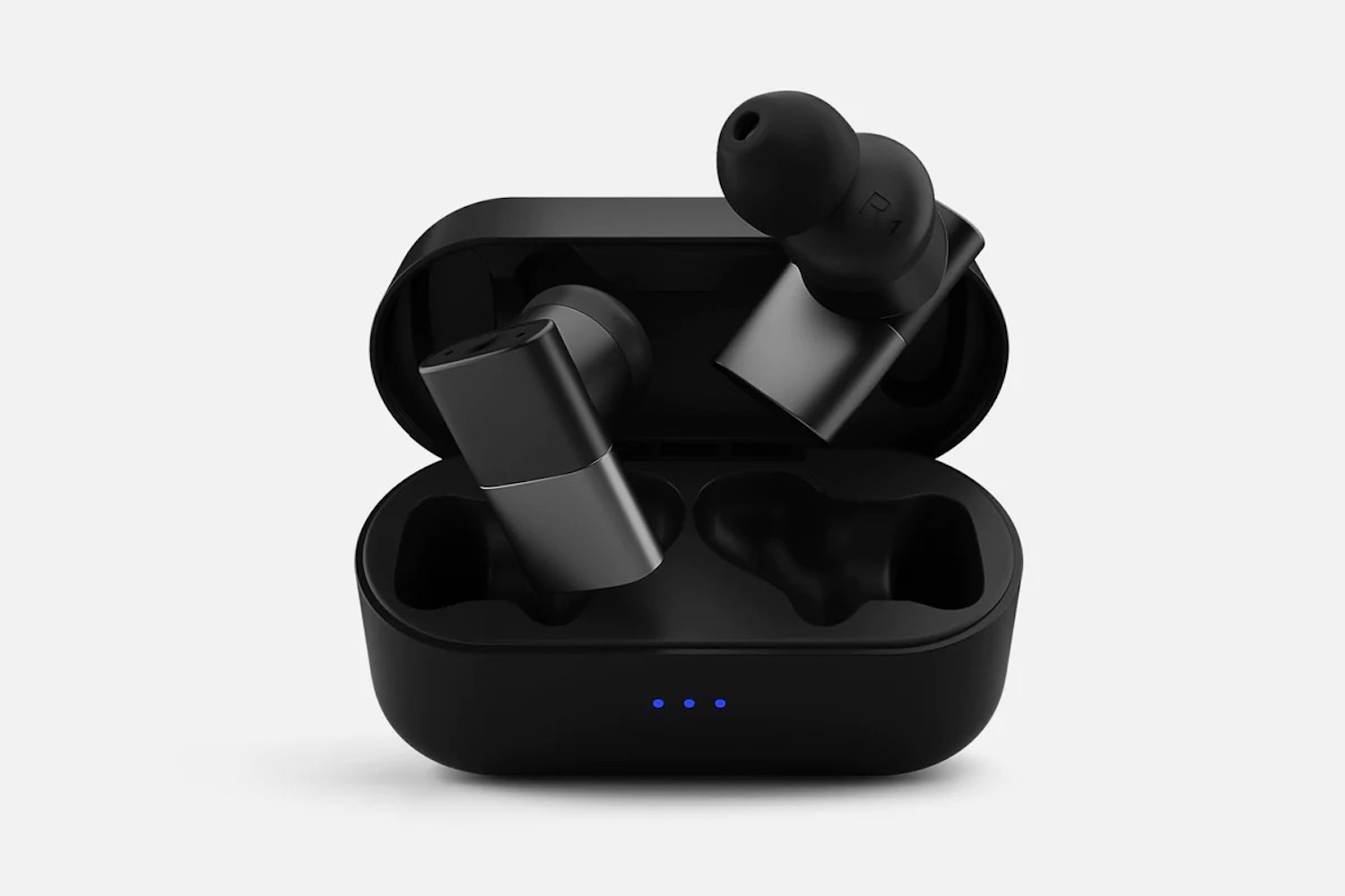 a pair of black status headphones on a grey background