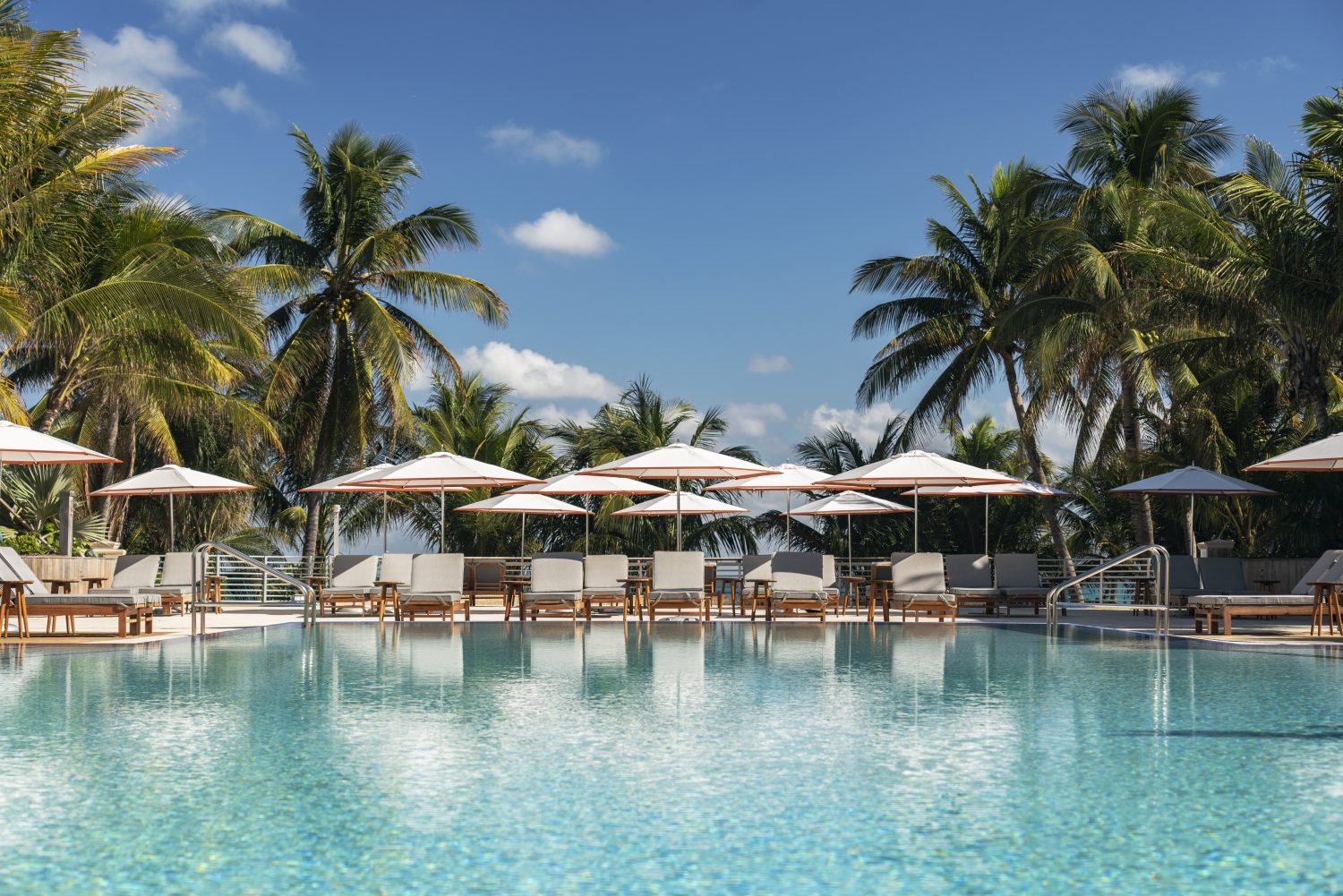 pool area with seating and umbrellas at the Ritz-Carlton, South Beach in Miami, Florida