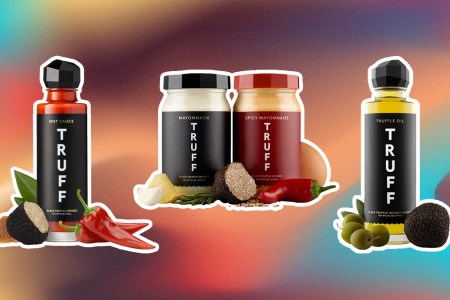 Truff bottles of hot sauce, truff oil and truff mayo products on an abstract pink and blue and red background