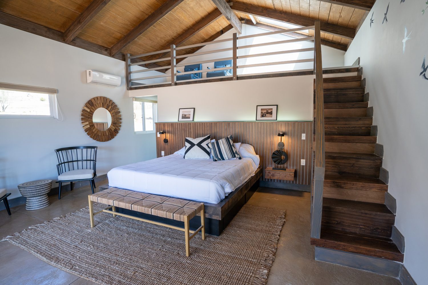 hotel room with bedding with upper loft area