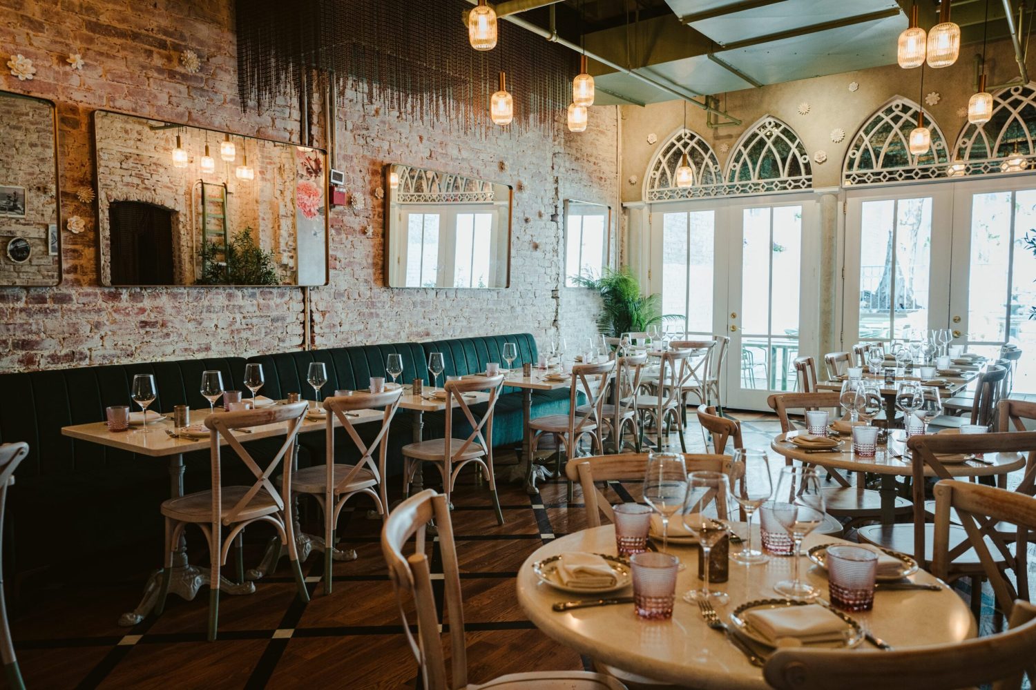 seating area with brick wall and white, pink and green accents.