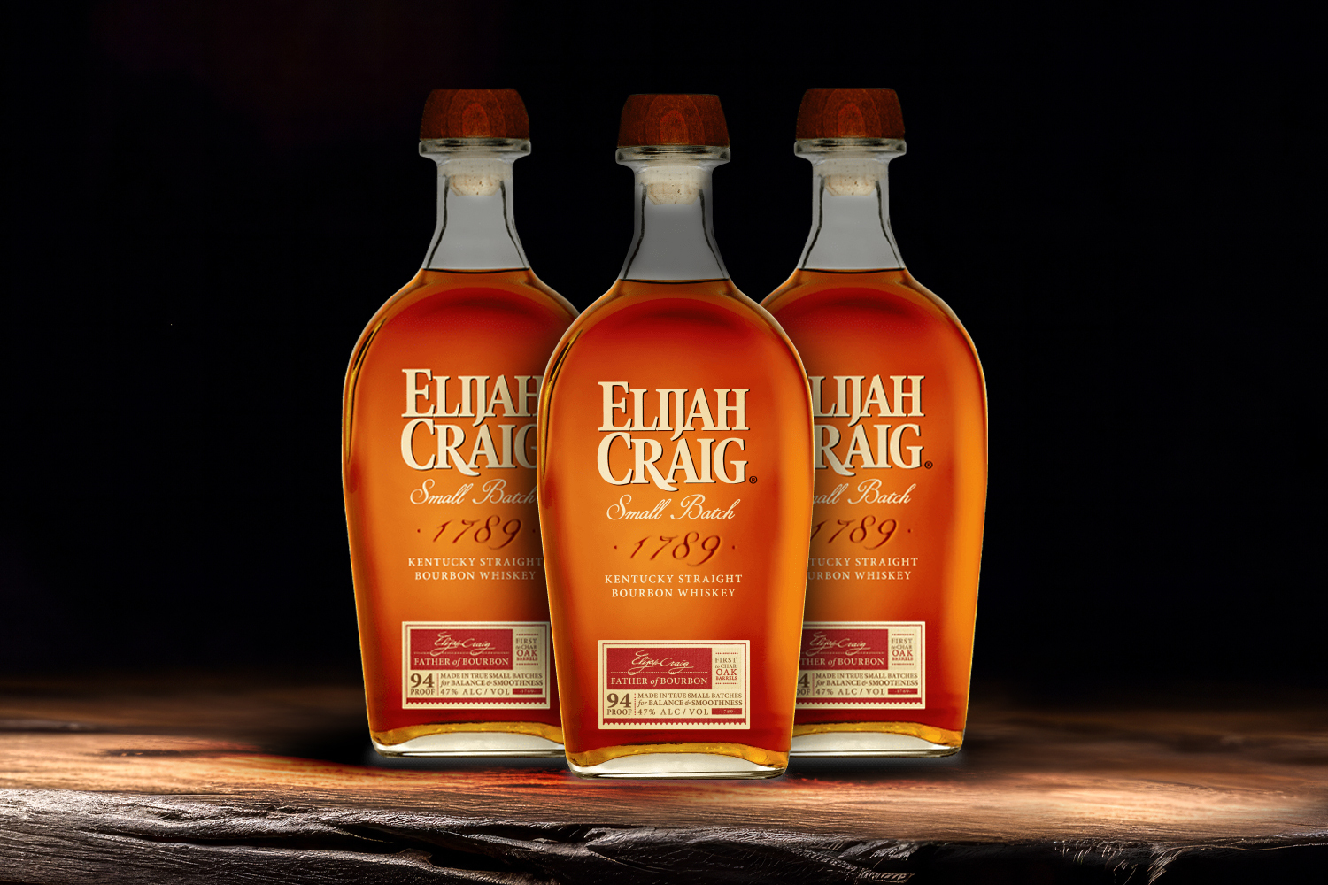3 bottles of elijah craig on a wooden table