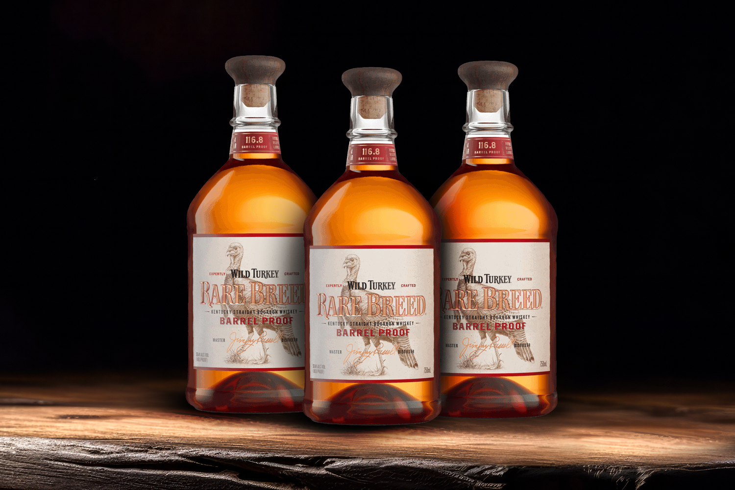 3 bottles of wild turkey rare breed on a wooden table