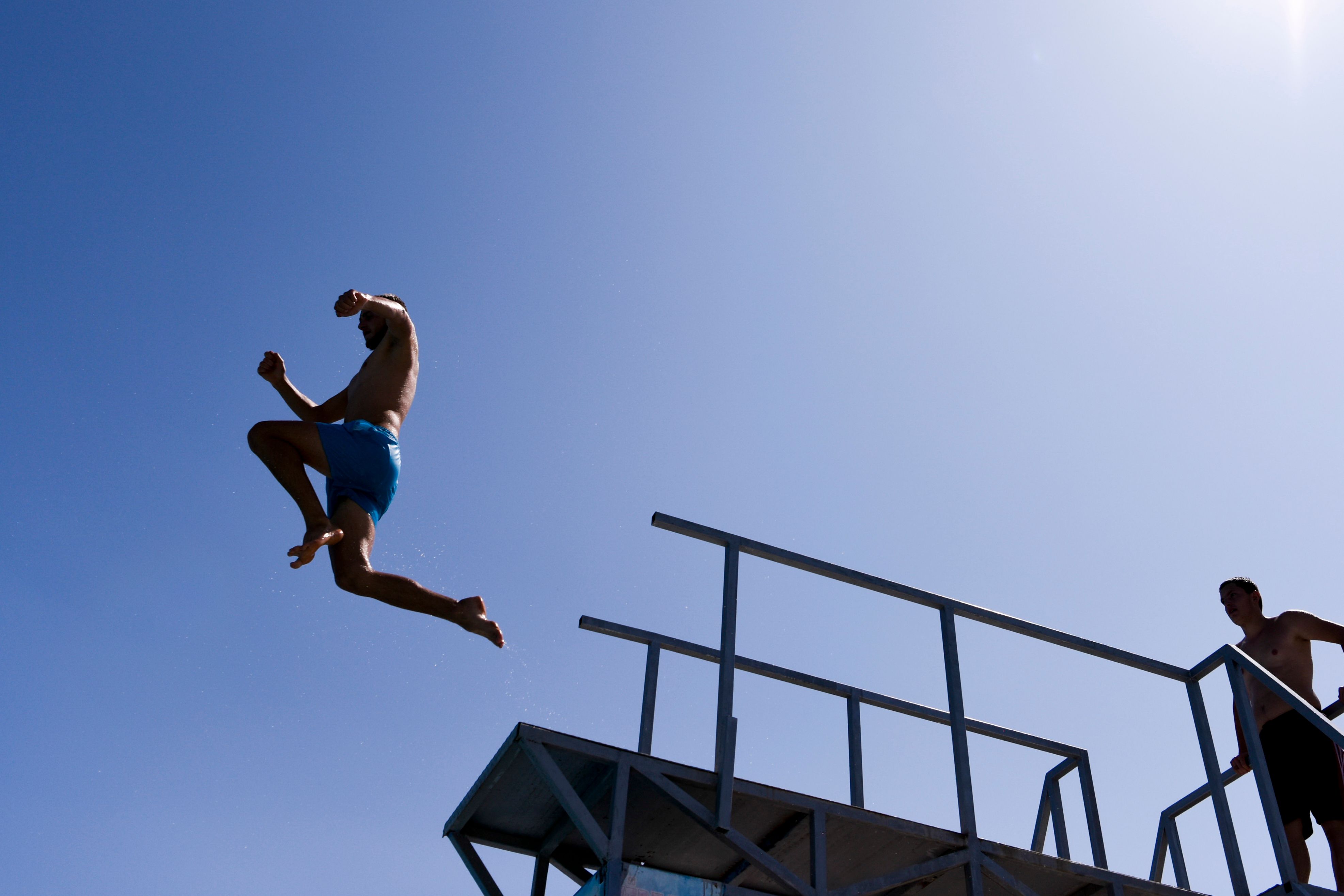 A man jumps off a diving board.