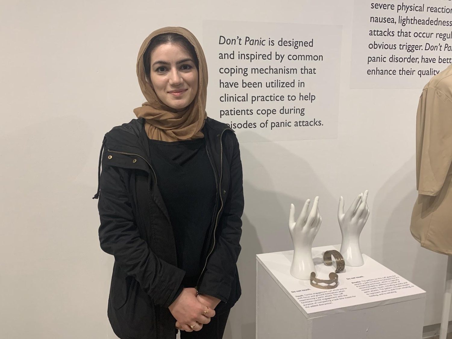 student posing with her artwork