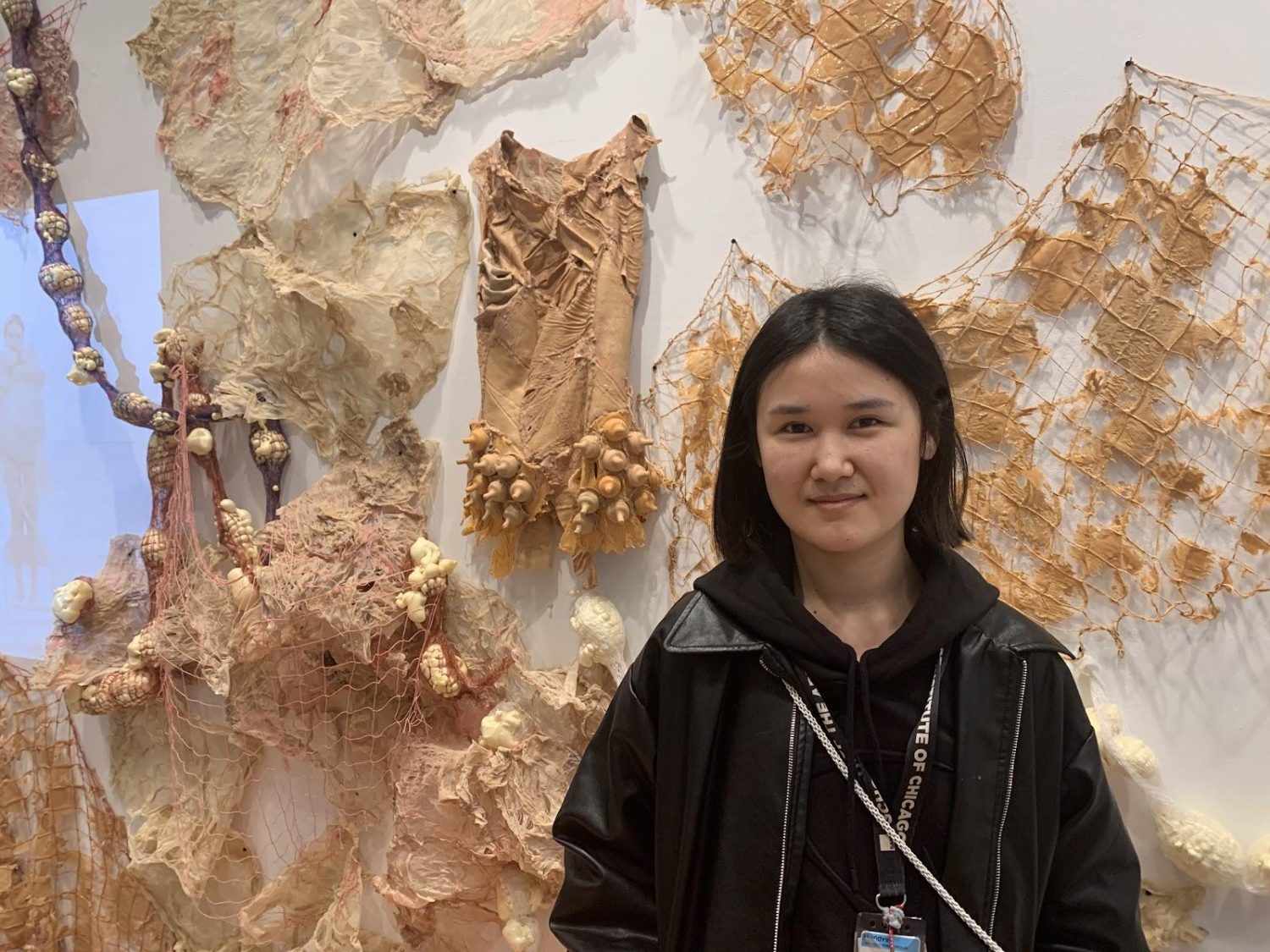 student posing with her artwork