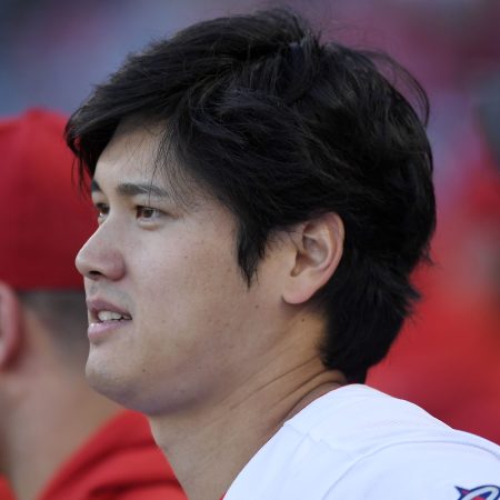 Shohei Ohtani looks at a game from the dugout.