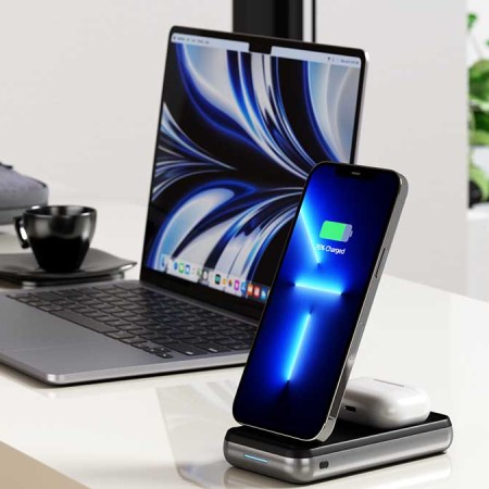 Satechi Duo Wireless Charger with a phone and earbuds charging, next to a computer