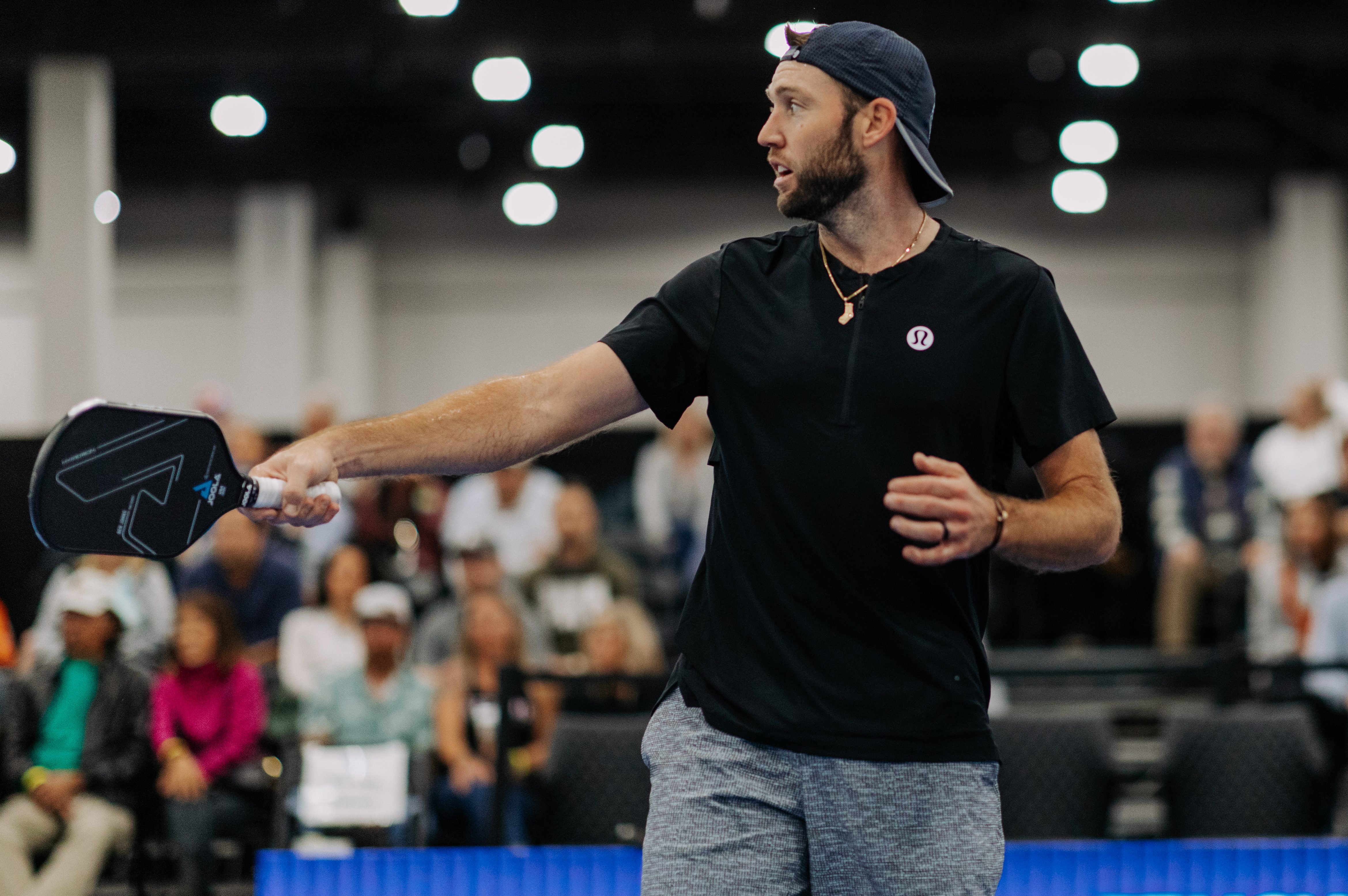 Jack Sock shooting his shot on the pickleball court.