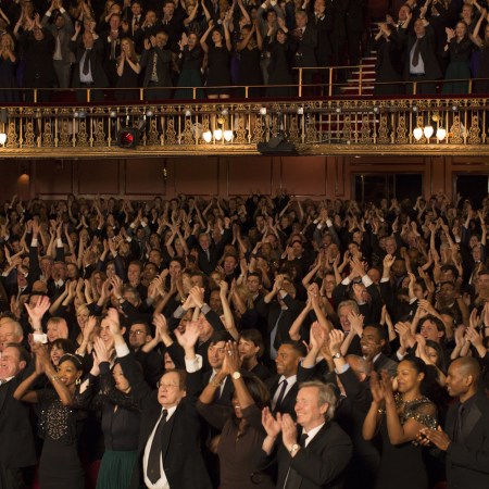 A crowd of people giving a standing ovation