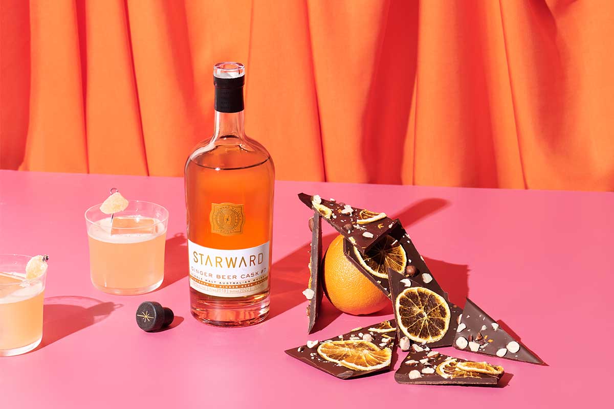 Starward Ginger Beer Cask #7 surrounded by oranges, chocolate and cocktails