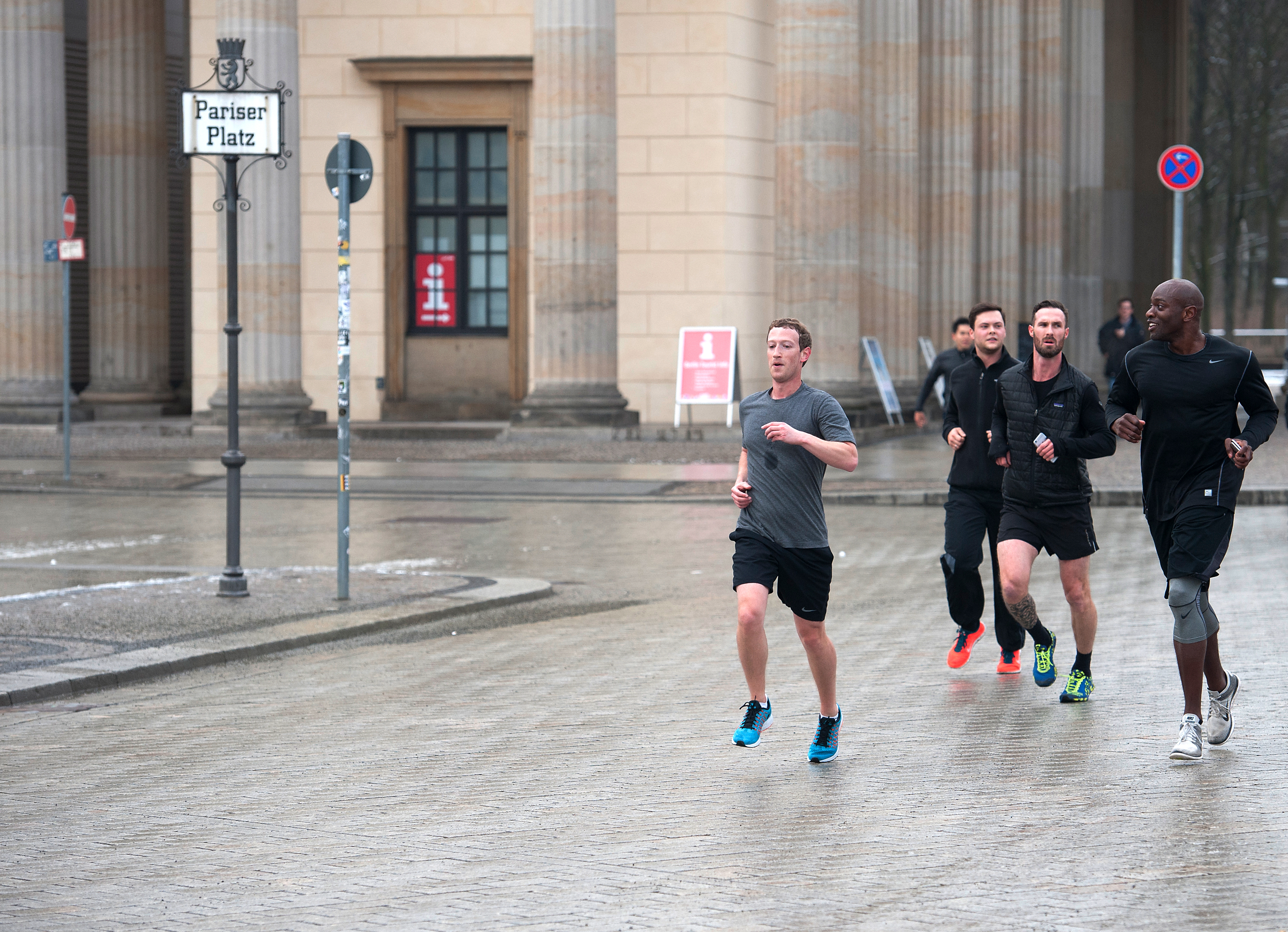Mark Zuckerberg running with bodyguards in Berlin.