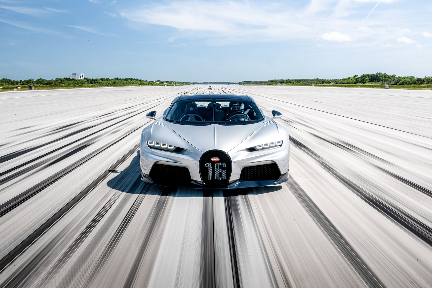 Car speeding fast down road.