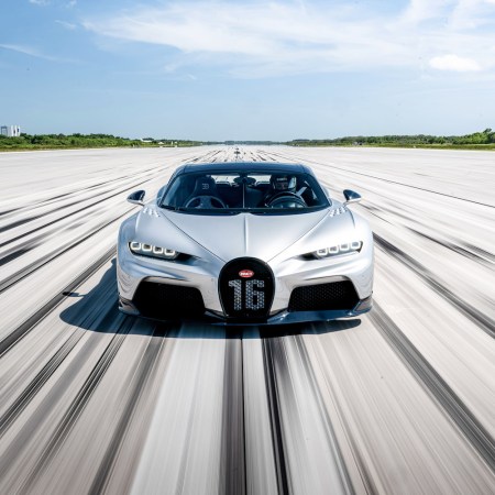 Car speeding fast down road.